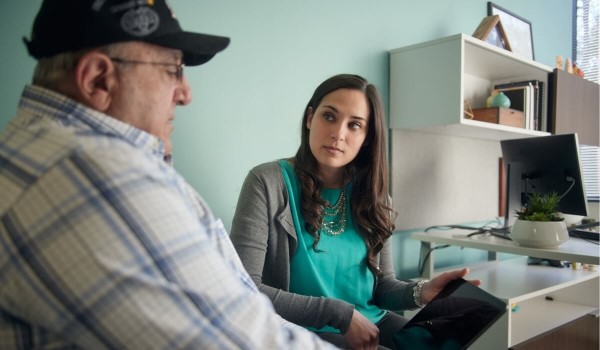Veteran and VA social worker looking at tablet